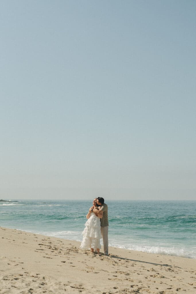 Candid engagement portraits in Laguna Beach at West Street Beach