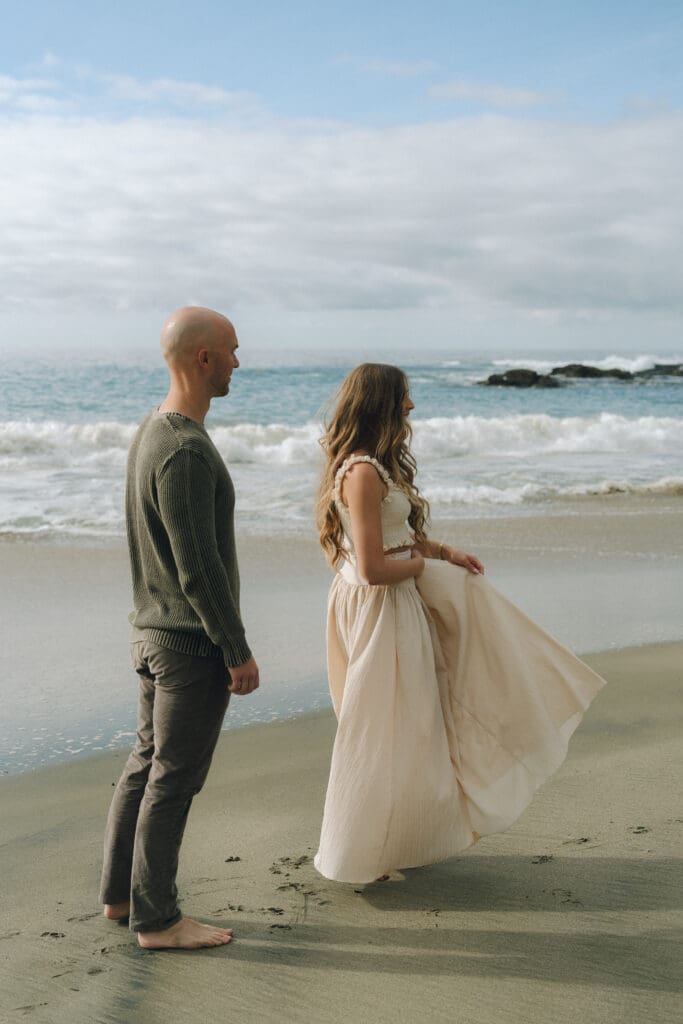 Pregnant woman in neutral dress during coastal maternity session