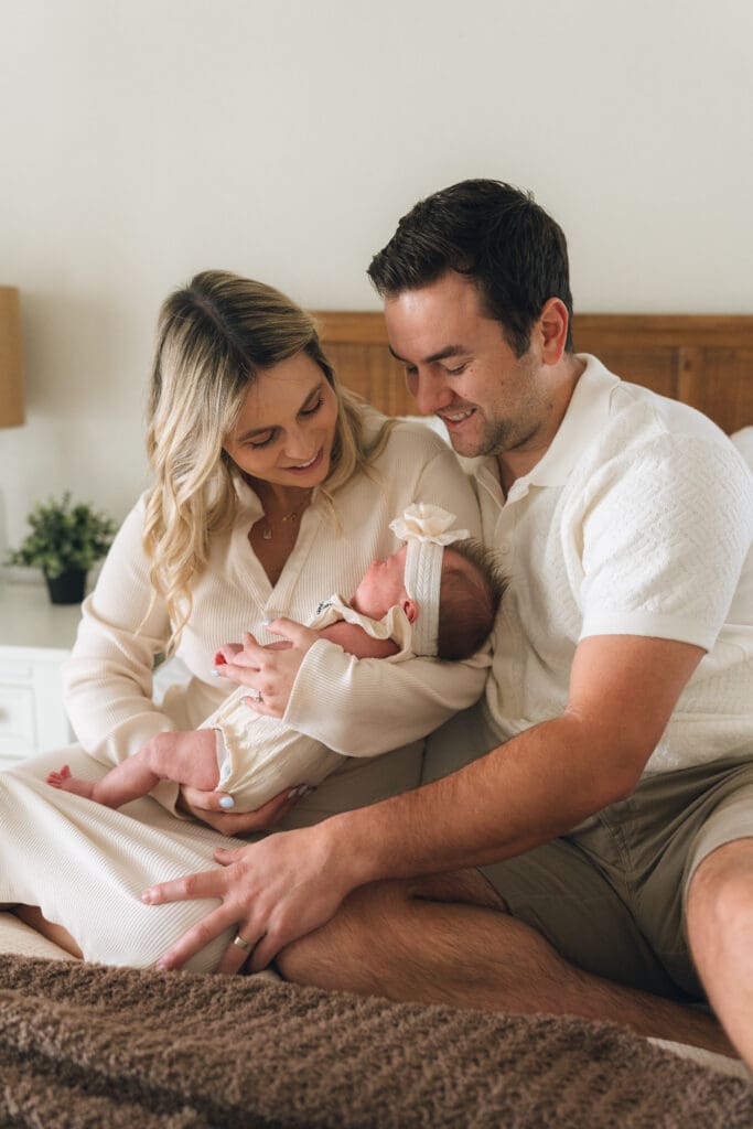 Family snuggling newborn at home in Orange County