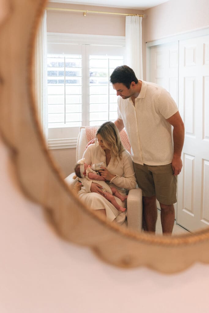 Mother holding baby in natural light during newborn session