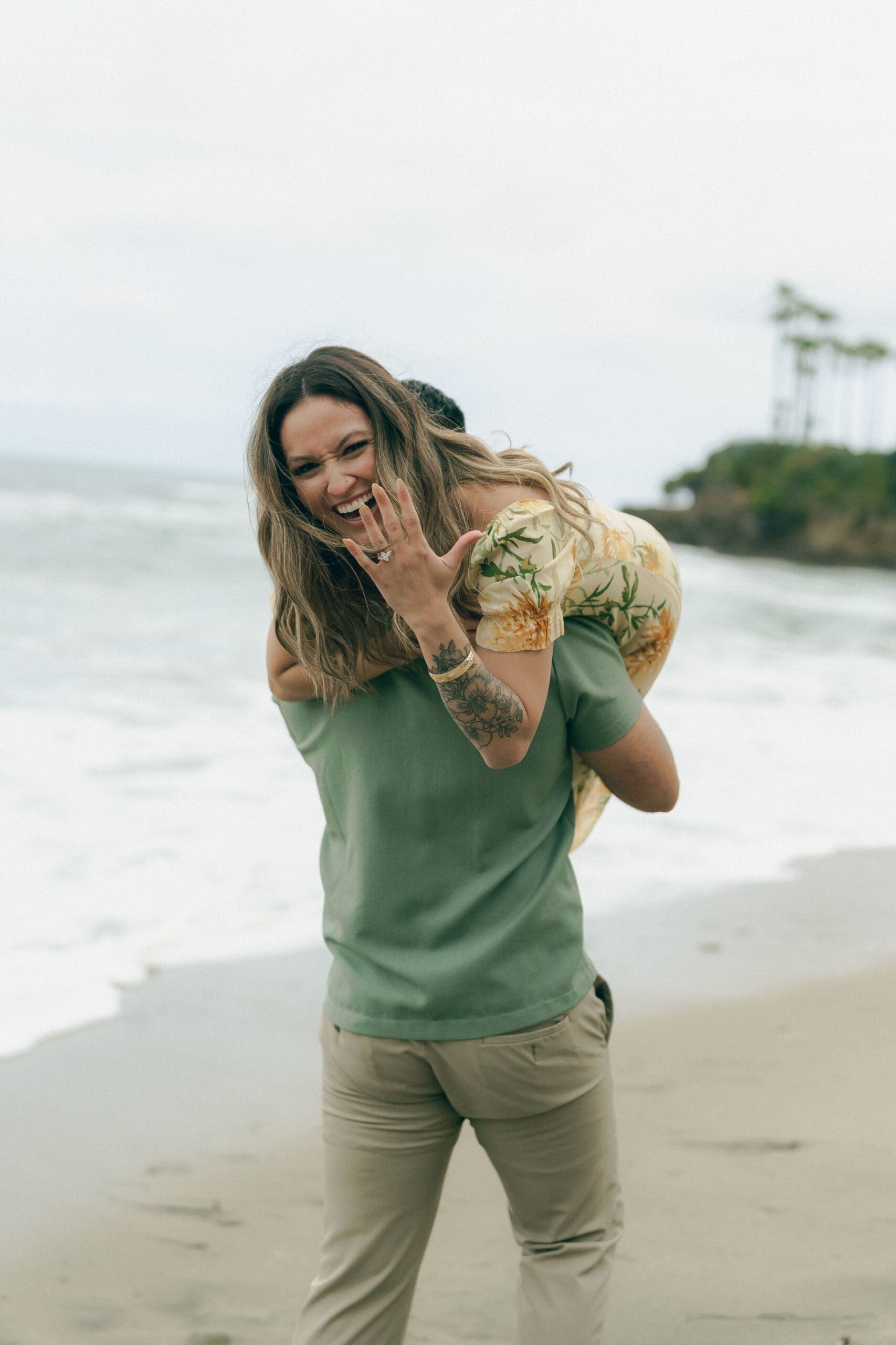 Casual and romantic looks for your beach engagement session in Laguna Beach: couple smiling on rocky cove